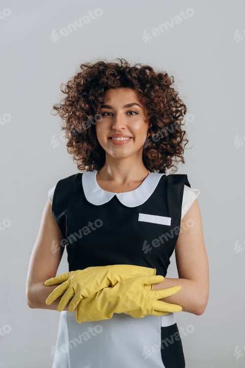 Preview: In protective gloves for cleaning the house. Beautiful woman is in the studio