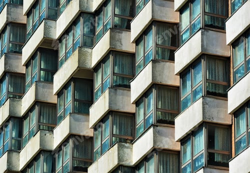 Preview: High building with lines of windows and balconies on a sunny day