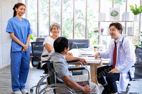 Preview: Senior couple male on wheel chair having consultations with doctor for their sickness at clinic