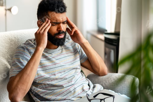 Preview: Stressed african american man suffering from strong headache and migraine pain