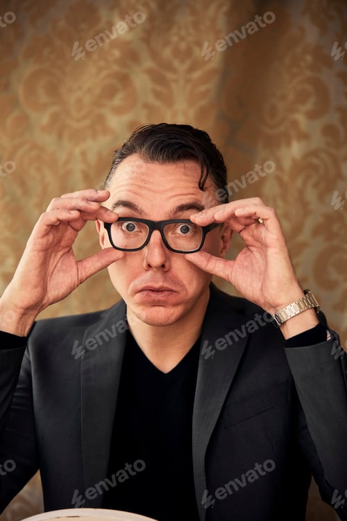 Preview: Comedian adjusting spectacles for clearer vision