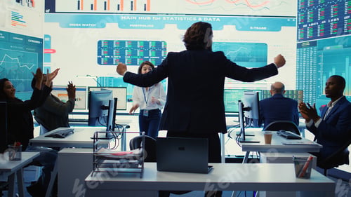 Preview: Business administrator celebrating expansion progress with his team
