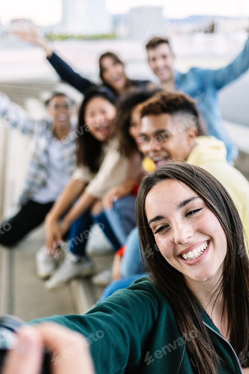 Preview: Vertical shot of multiracial young group of friends taking a selfie photo
