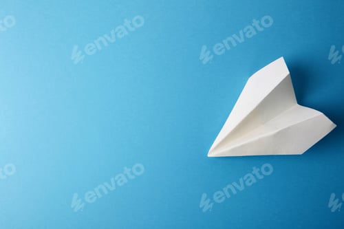 Preview: Flat lay of white paper plane and blank paper on pastel blue color background.Horizontal.