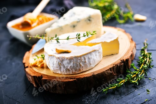 Assortment of Fine Cheeses on a Wooden Board