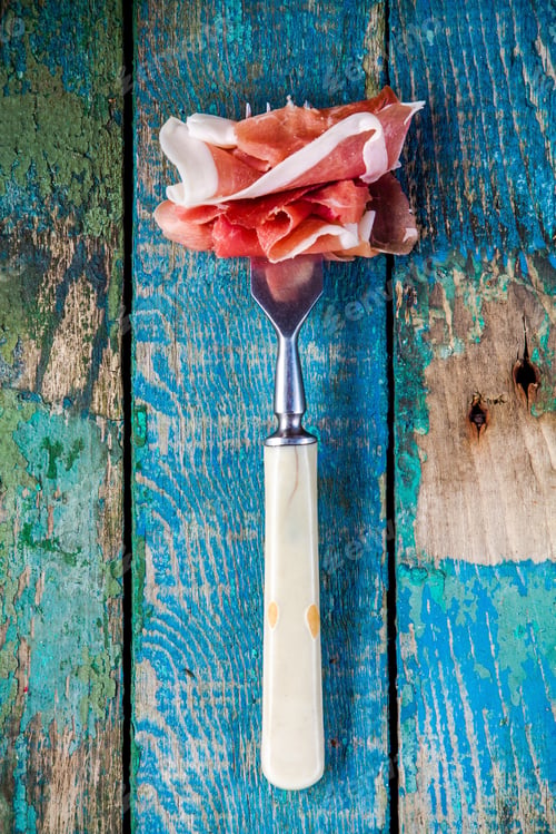 Preview: appetizer: fork with prosciutto closeup