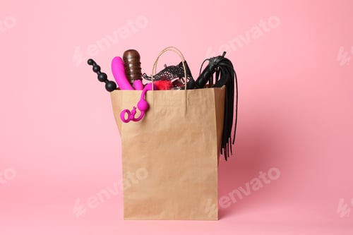 Preview: Paper shopping bag with different sex toys on pink background
