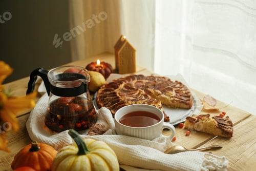 Preview: Autumn hygge still life. Warm tea in stylish cup on rustic table with freshly baked apple pie