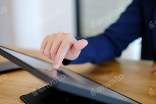 Preview: Portrait of business professional lady working at computer in the office or networking space.