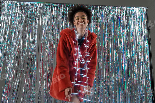 Preview: Beautiful And Happy Girl With Makeup In A Fur Coat Posing With Christmas Decorations