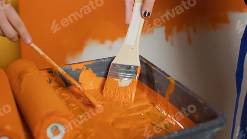 Preview: Mom and kid painting walls with orange color and paintbrush