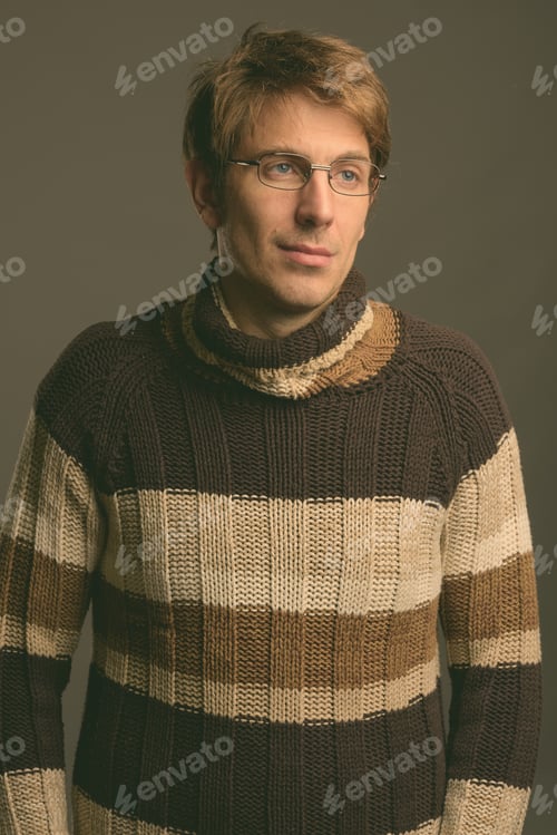 Preview: Handsome man wearing eyeglasses against gray background