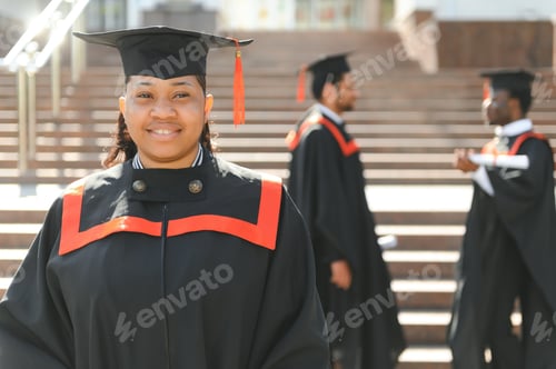 Preview: pretty african female college graduate at graduation with classmates