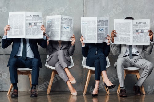 Preview: businesspeople in formal wear sitting on chairs and holding newspapers in front of faces in waiting