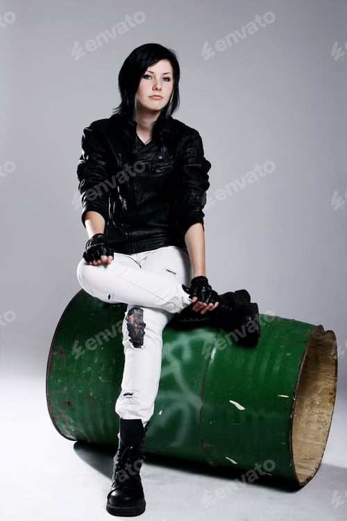 Preview: Punk girl sitting on metal barrel