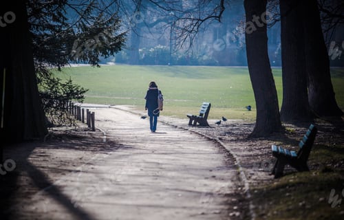 Preview: Lonely woman walking along in the park