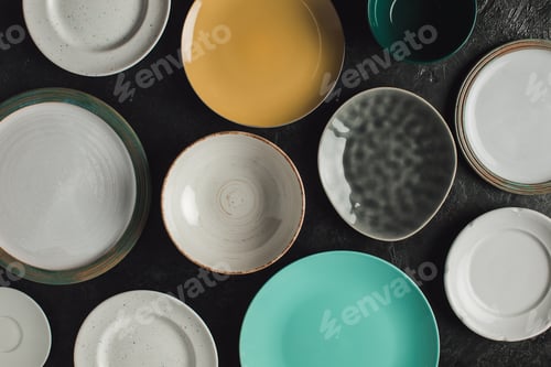 Preview: top view of various arranged ceramic plates isolated on black surface