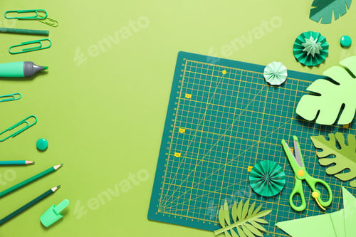 Preview: Concept of accessories for patchwork on a green background, mat cutting