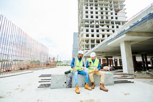 Preview: Construction engineers with smartphone during break