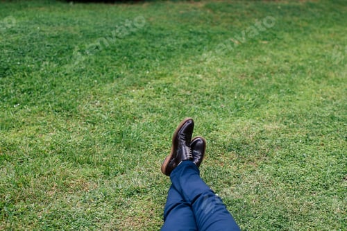 Preview: A man lies on the grass in beautiful shoes