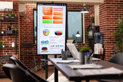 Preview: Monitor with marketing graph on it standing in empty startup business office