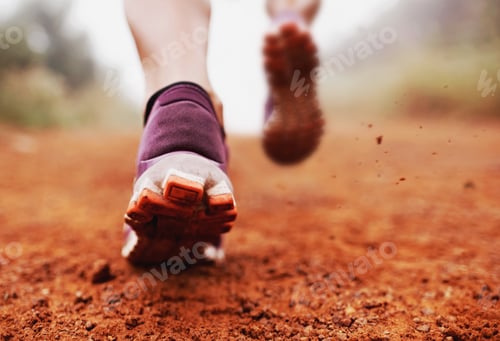 Preview: Ripping up the trail. Closeup shot of a woman running on a trail on a misty morning.
