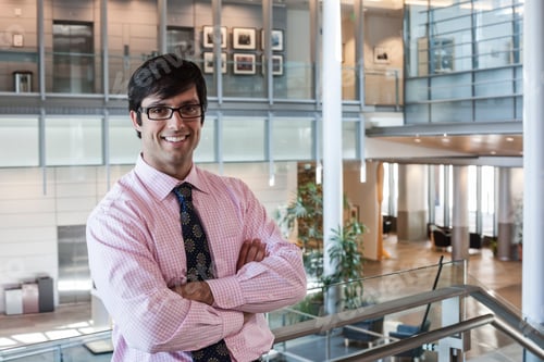 Preview: Hispanic business man in an office lobby.