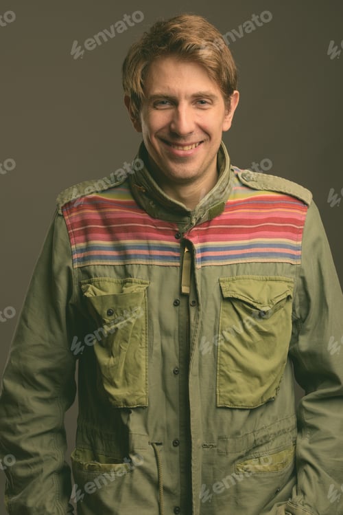 Preview: Handsome man against gray background