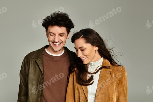 Preview: Stylish young couple embracing modern fashion in a minimalist setting