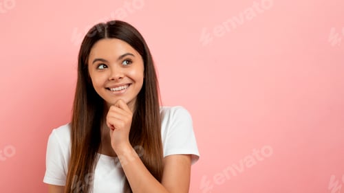 Preview: Pensive teenage girl smiling and looking curiously at copy space