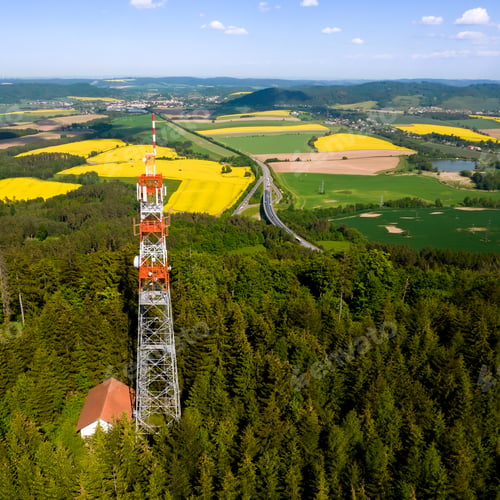 Preview: Transmitter tower in a field covered in greenery under the sunlight in the countryside