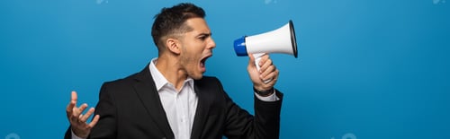 Preview: Side view of businessman screaming in loudspeaker isolated on blue, panoramic shot