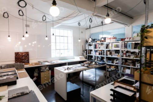 Preview: Interior of illuminated light bulbs hanging from ceiling in creative office