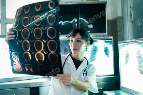 Preview: Portrait of young doctor checking X-Ray in hospital to make diagnosis
