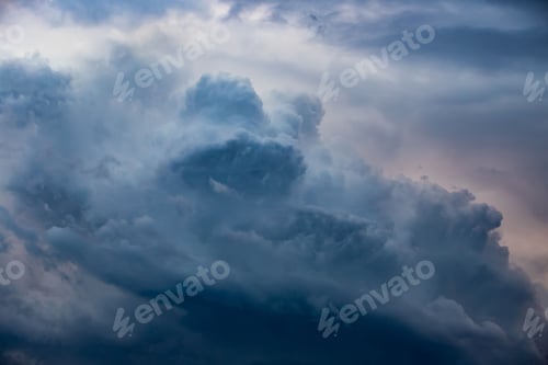 Preview: this is a cloudy sky with dark clouds behind it and a blue and purple sky