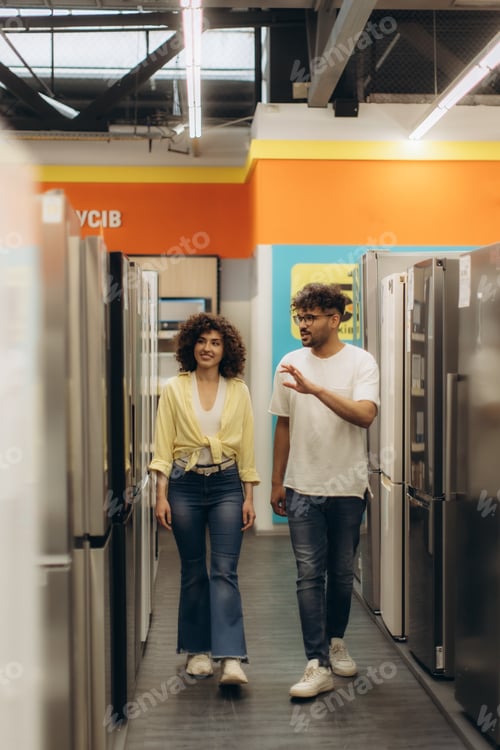 Preview: Couple Exploring Modern Refrigerators in a Vibrant Electronics Store
