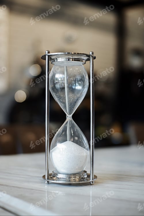 Preview: Sand running through the bulbs of an hourglass measuring the passing time