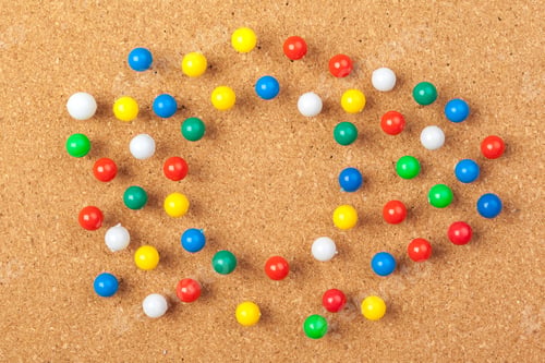 Preview: Group of thumbtacks pinned on corkboard