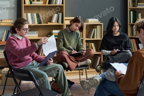 Preview: Diverse Teenagers Engaging in Group Therapy Discussion and Completing Worksheets