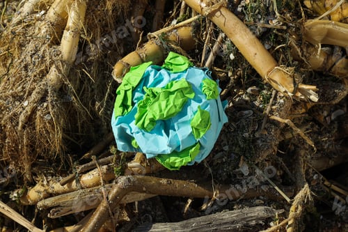 Preview: A paper model of the Earth is crumpled on the garbage