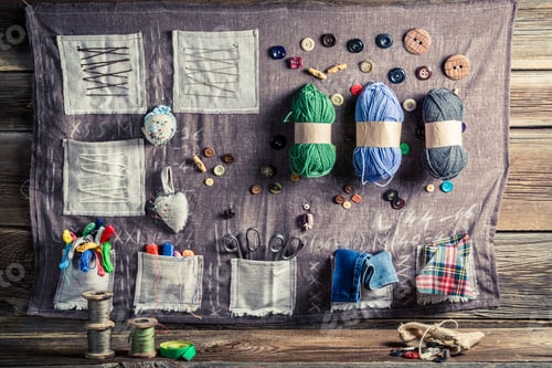 Preview: Vintage sewing mat made of threads, needles and buttons in tailor workshop