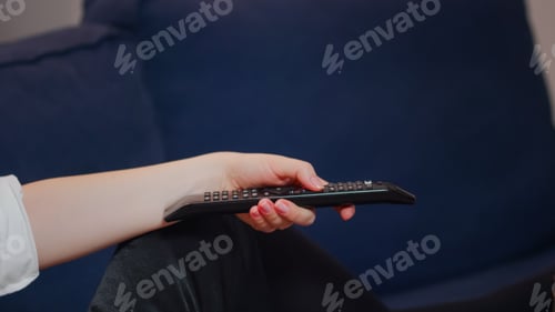 Preview: Close up of hand holding remote for television