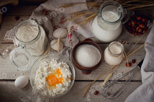 Preview: Fresh dairy products: milk, cottage cheese, sour cream and wheat on rustic wooden background.