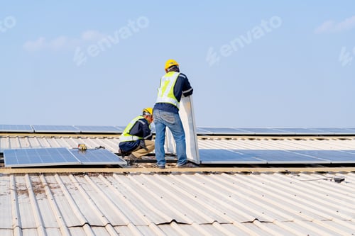 Preview: workers installing solar panels, for efficient energy on rooftop