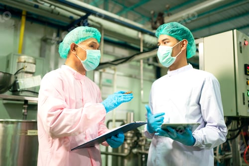Preview: worker working in drink factory at conveyor belt with fruit juice glass bottled in production line