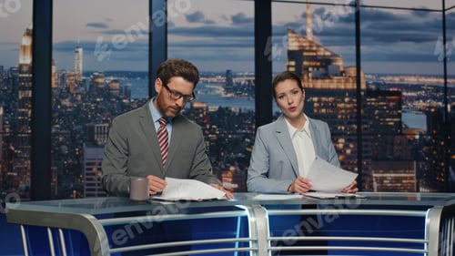 Preview: Professional television presenters talk evening newscast modern studio closeup