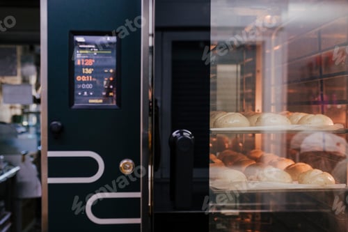 Preview: bread baking in oven. Production oven at the bakery. Baking bread. Manufacture of bread