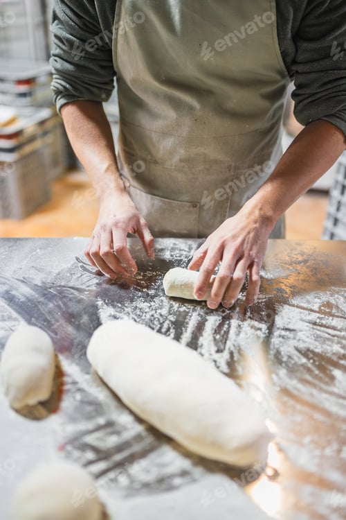 Preview: Baker kneading dough in bakery, preparing bread and pastry