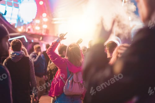 Preview: Festive Crowd Enjoying Outdoor Music Concert at Night