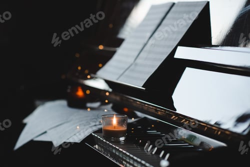 Preview: Piano keys with burning candles close up